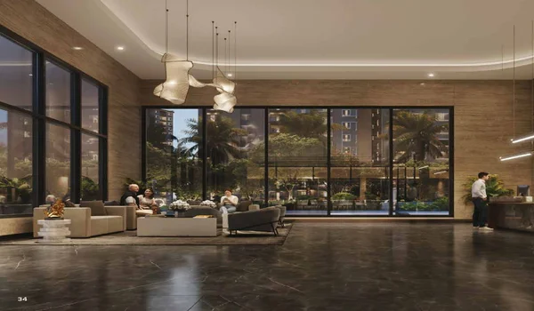 A high-end architectural rendering of the grand lounge at Sattva City. The space features double-height ceilings, polished dark marble flooring, and expansive floor-to-ceiling glass walls that look out onto a lit-up courtyard with palm trees. Modern designer pendant lights hang over a sophisticated seating area with plush armchairs and coffee tables, creating a warm, hotel-style ambiance for residents.